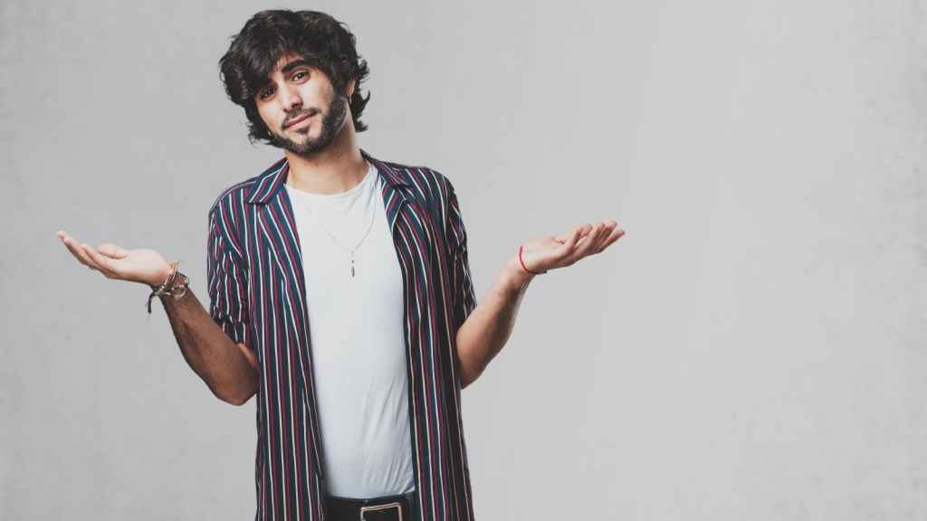 A young man shrugging