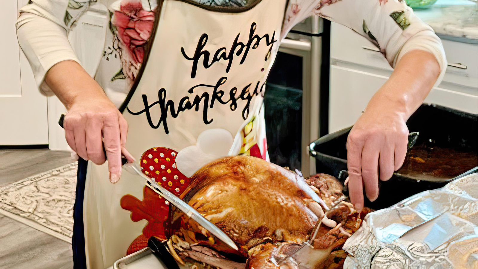 A woman carving a Thanksgiving turkey