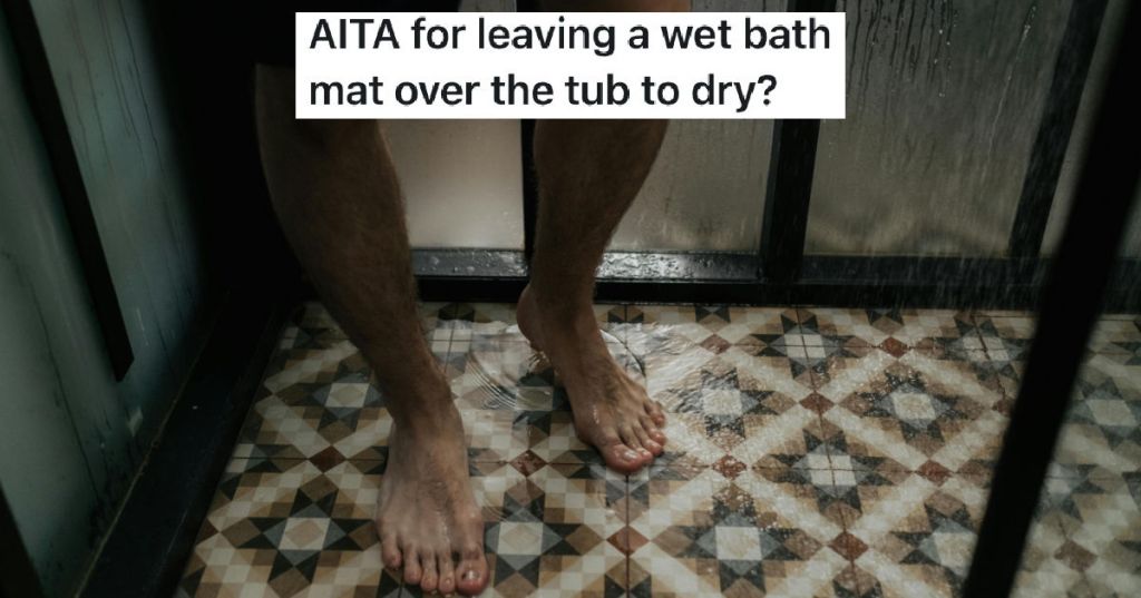 man stepping onto wet bath mat
