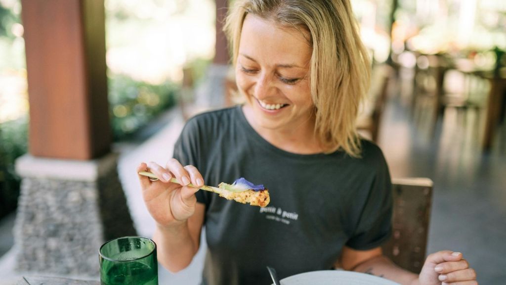 woman smiling and eating