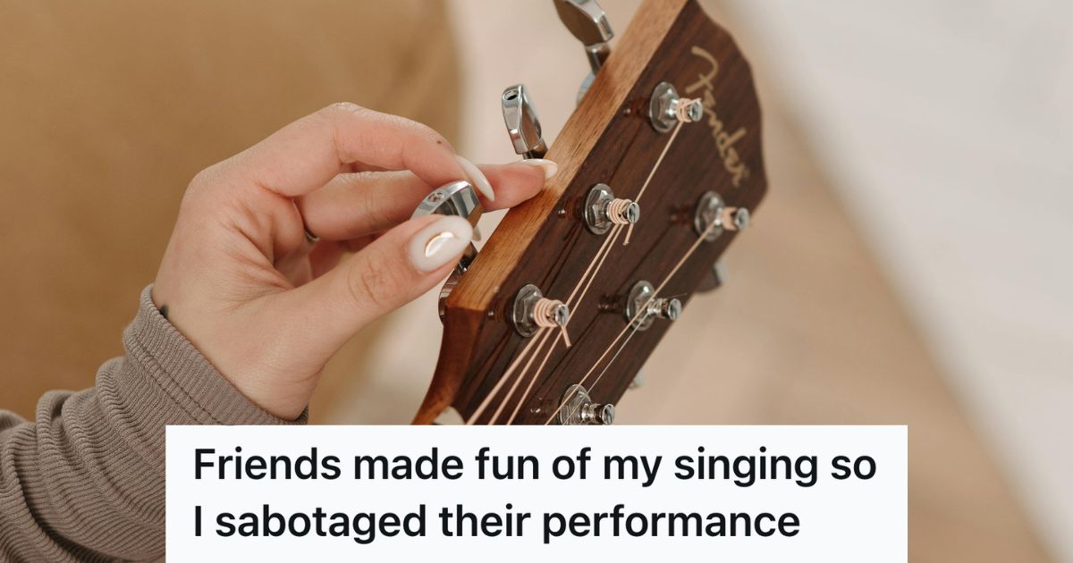woman tuning a guitar