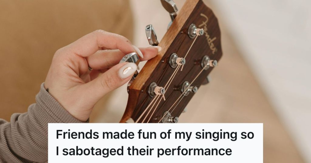 woman tuning a guitar