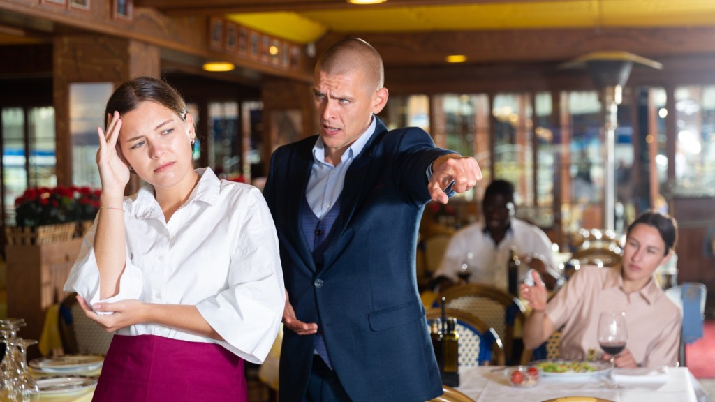A man yelling at a woman in a restaurant