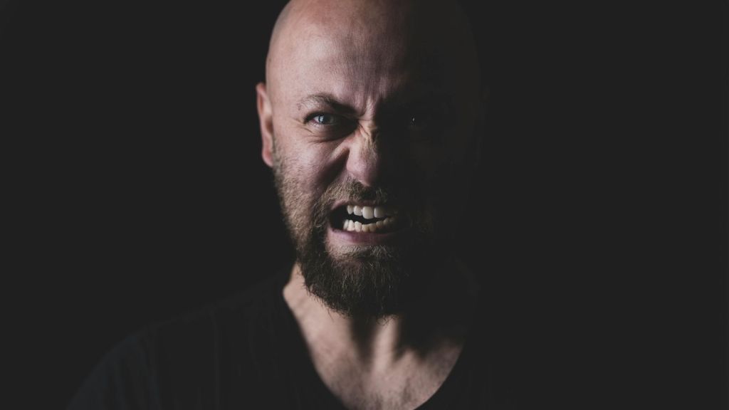 An angry man in a black t-shirt