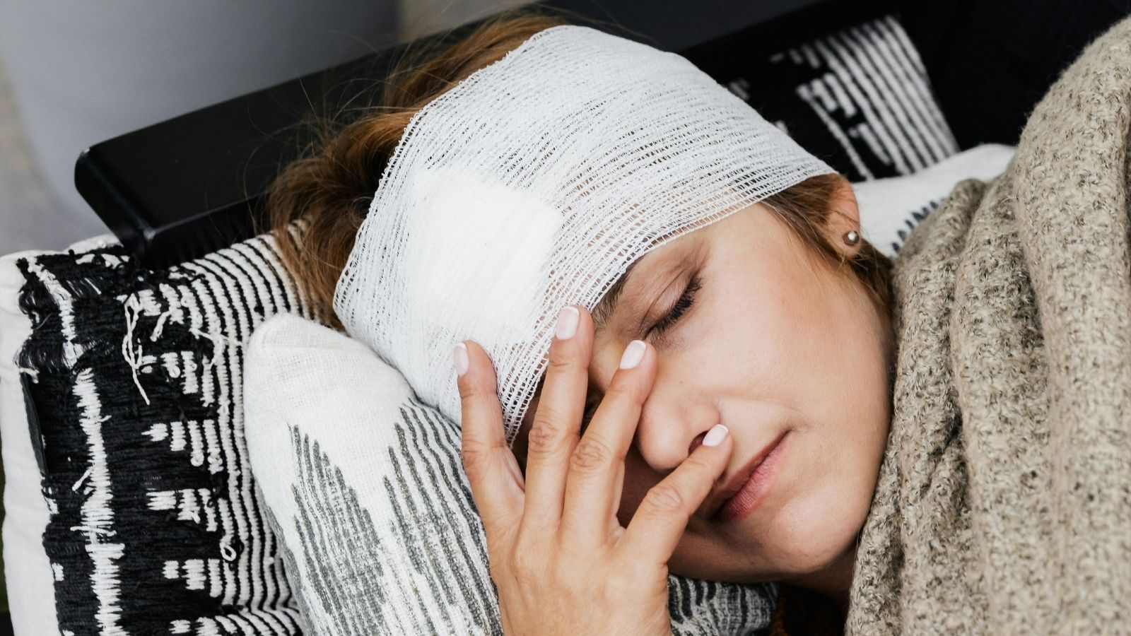 A woman with a bandaged head