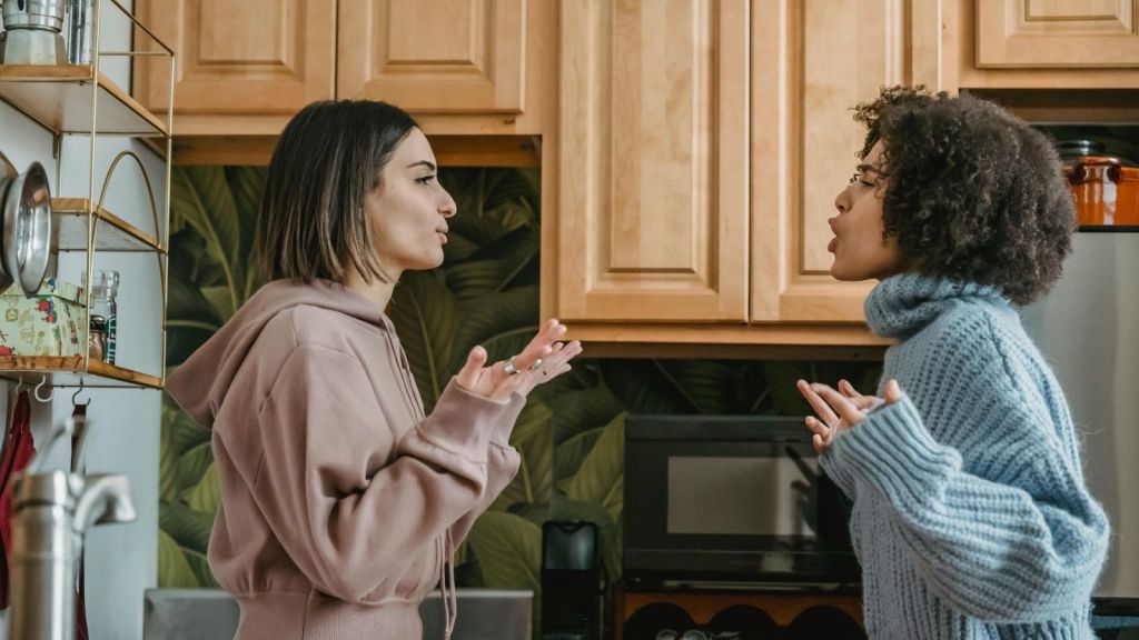 Two women arguing in a kitchen