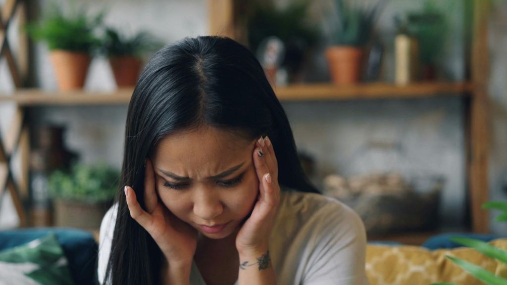 A woman with her head in her hands