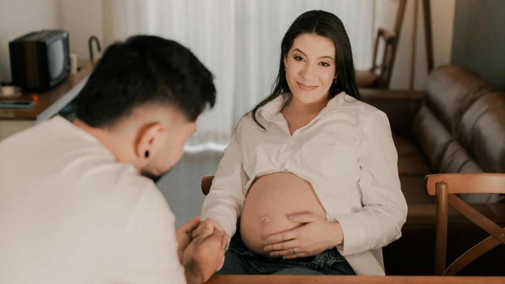 Expecting couple sitting at home