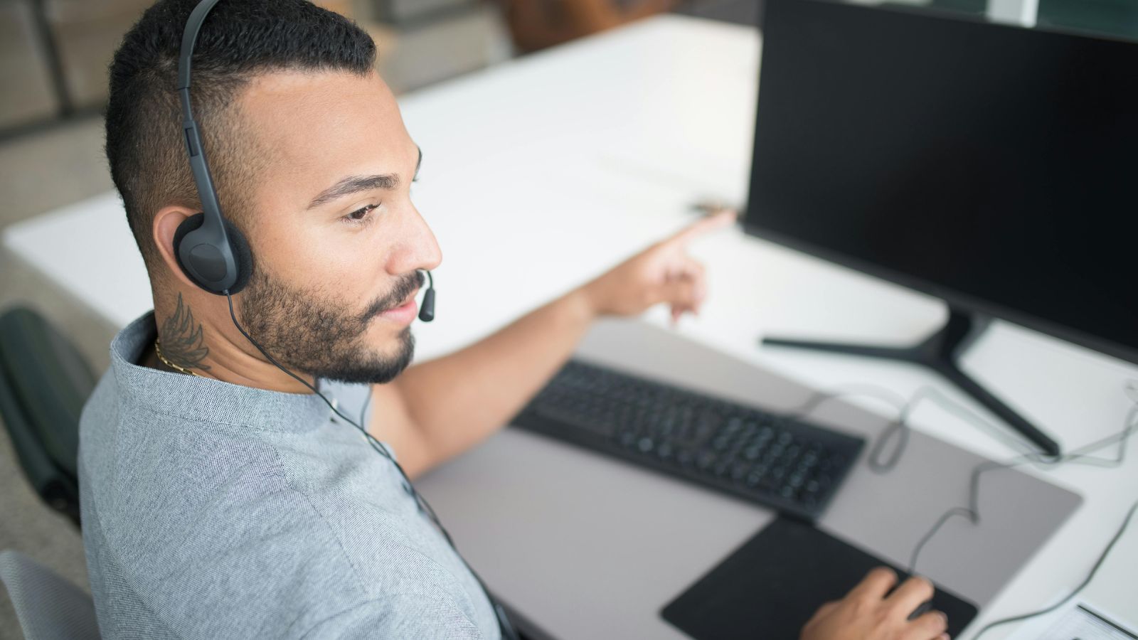 Call center employee with a headset and computer