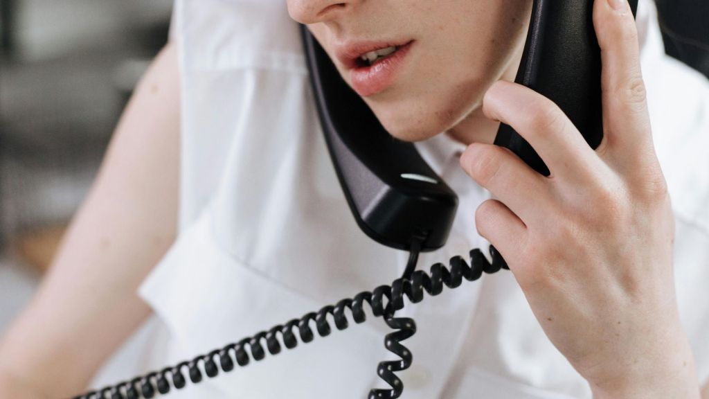 Woman talking on two telephones