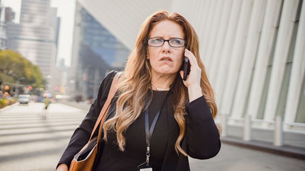 Frowning woman talking on the phone