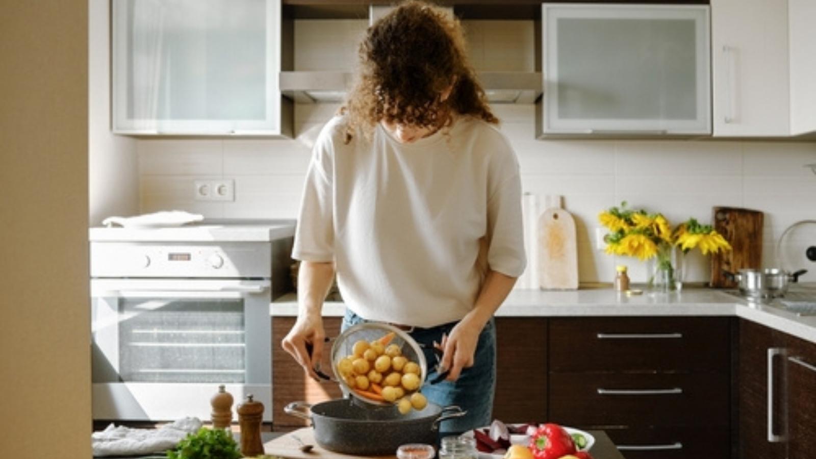 Woman boiling potatoes