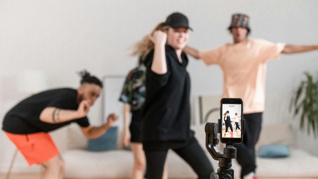 People filming a dance in front of a phone
