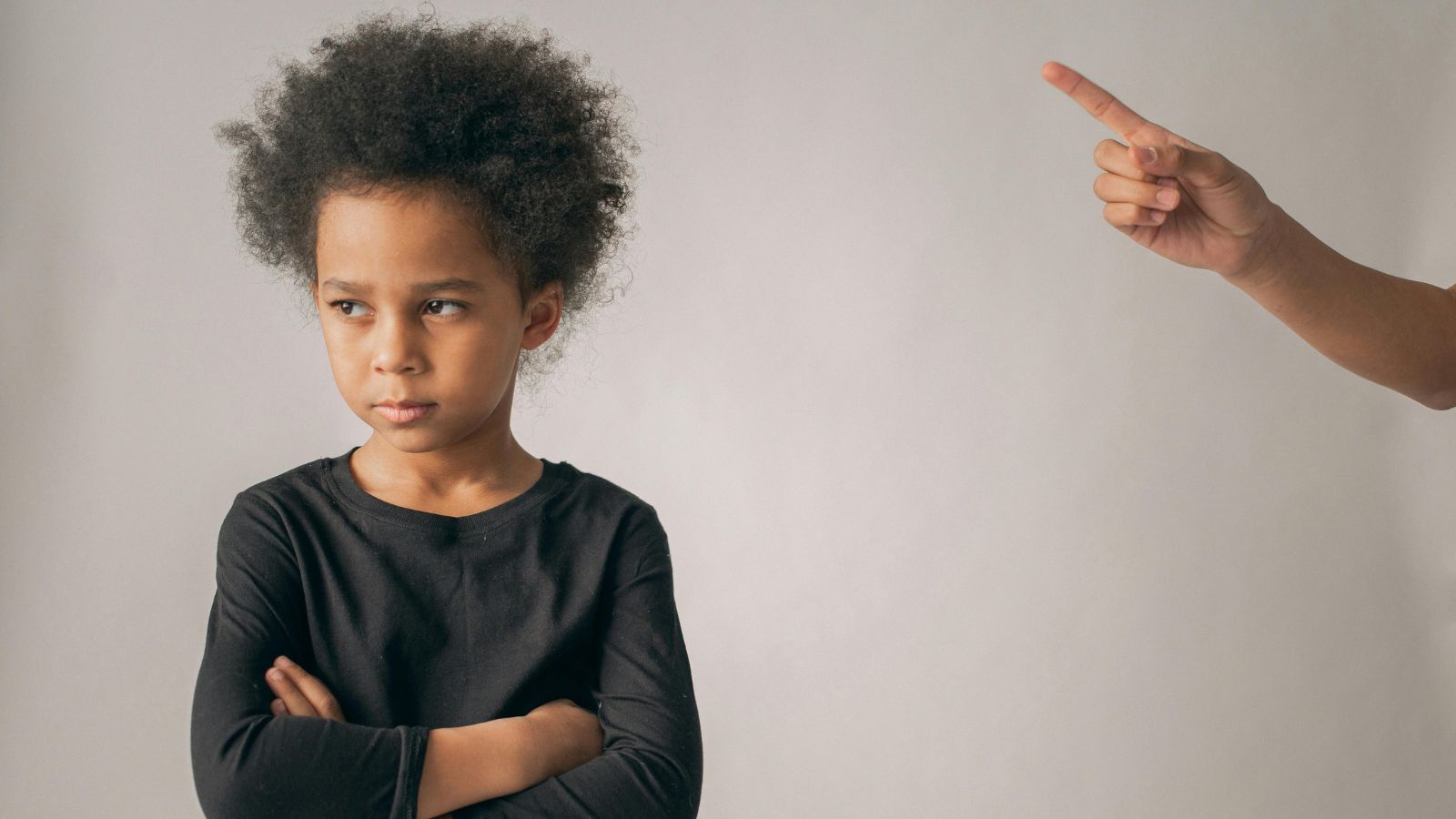 A Public Encounter With a Rude Child Leads to Unexpected Parental Backlash Adult hand gesturing an angry kid to stop