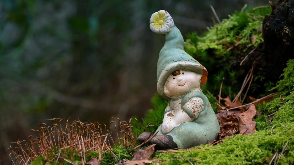 Garden gnome sitting on grass