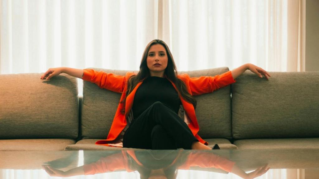 Woman sitting on a couch thinking about a creep at work