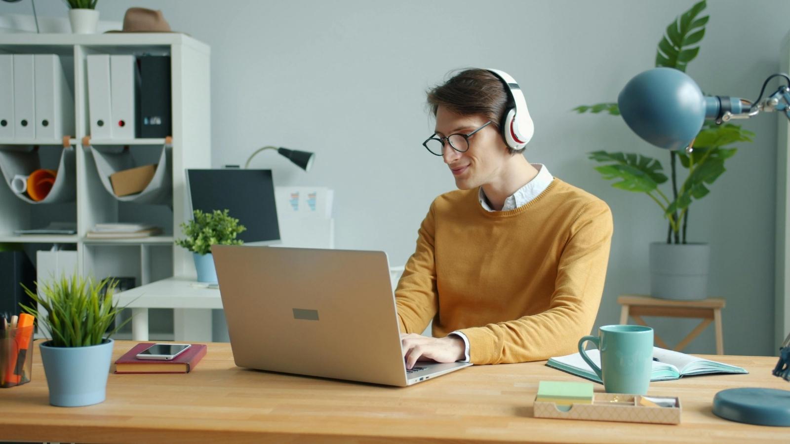 Man working at computer checking people's social media usage