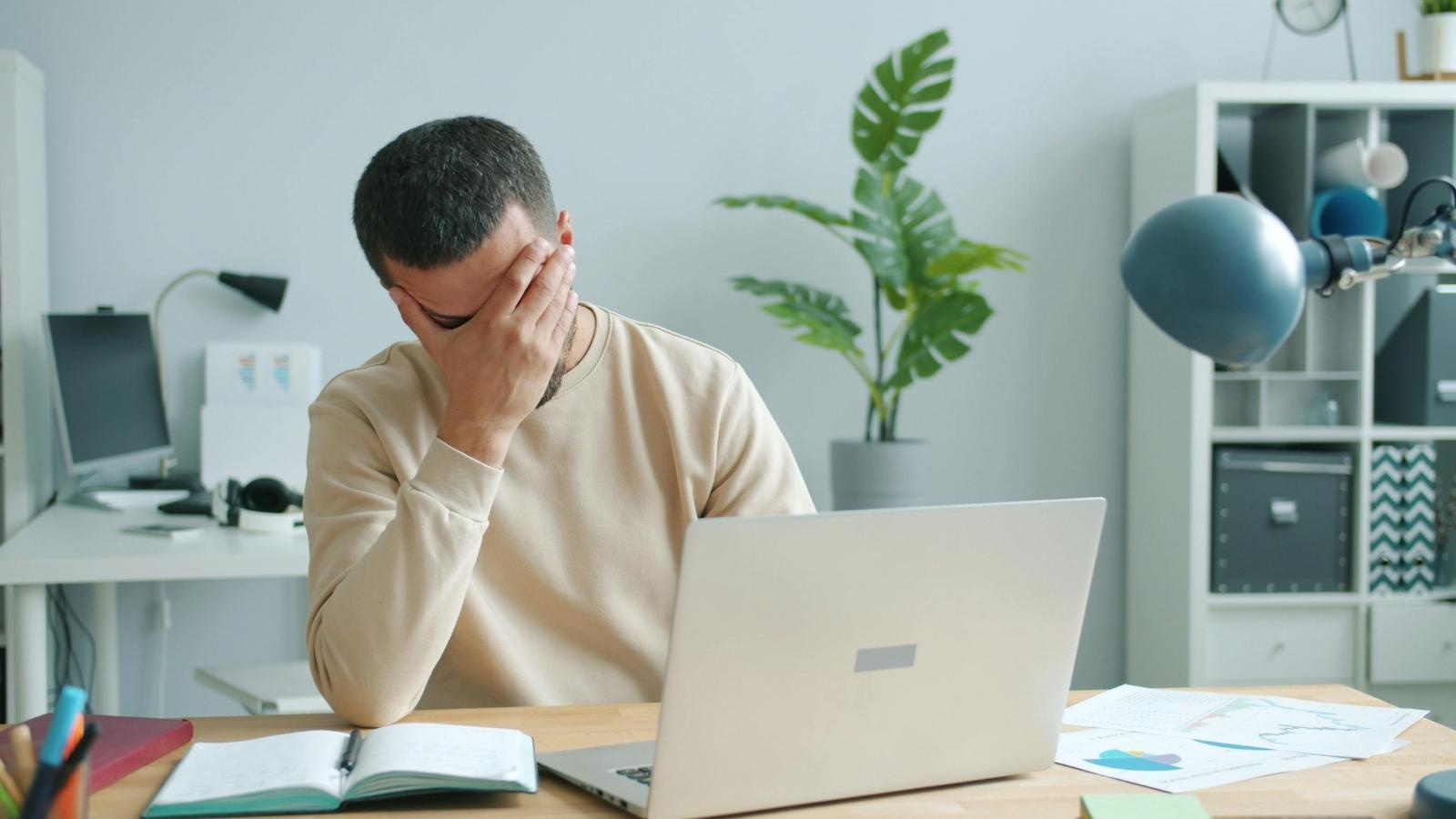 A Private Birthday Message to a Former Friend Leads to Unexpected Relationship Tension Man sitting at his desk feeling bad about a disagreement