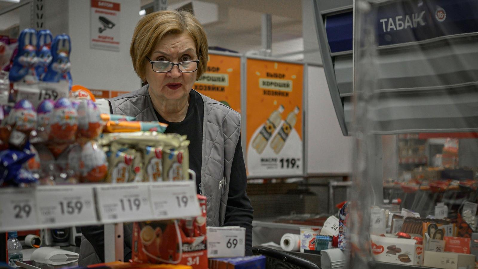 Older woman working the register at a pharmacy store