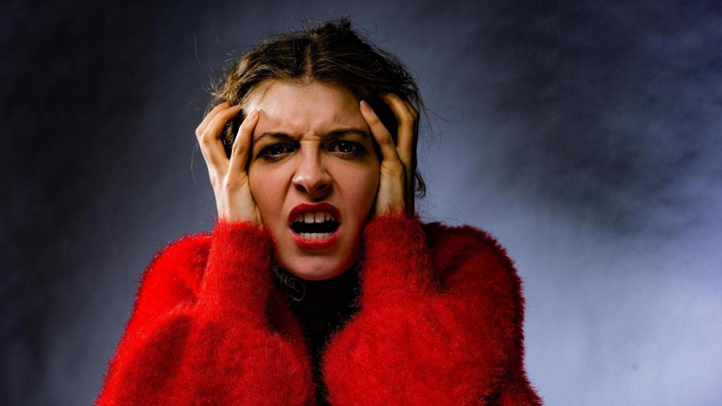Woman holding her head because her bf is driving her nuts