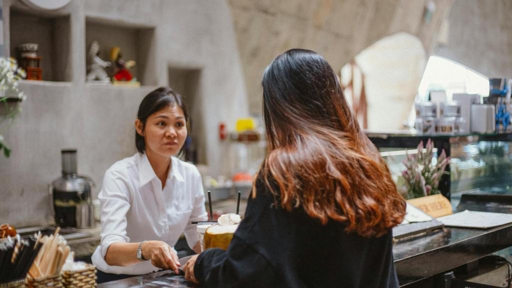 Woman manager yelling at a server for moving customers
