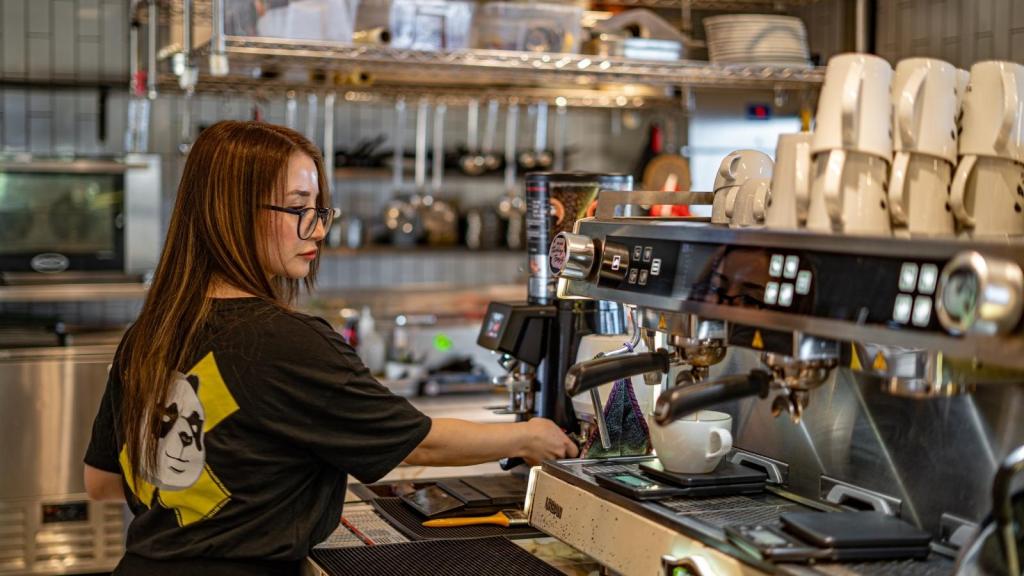 Barista making a cup of coffee for a customer