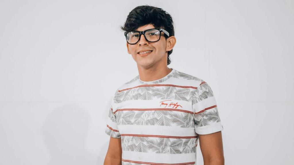 Nerd wearing glass, smiling at the camera