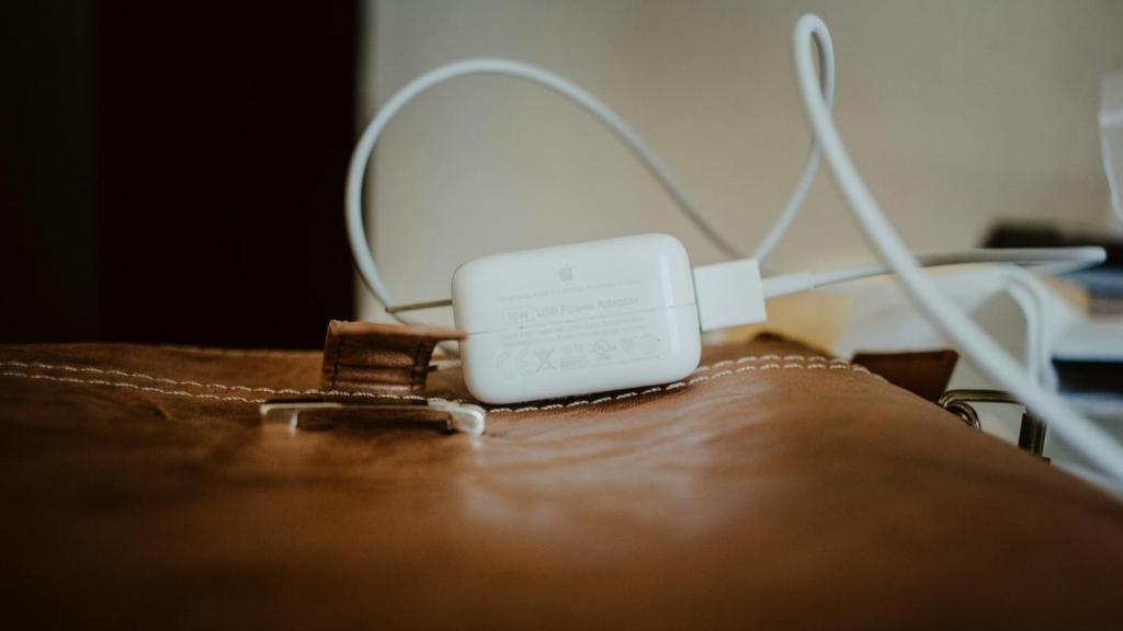 Phone charger laying on top of a briefcase