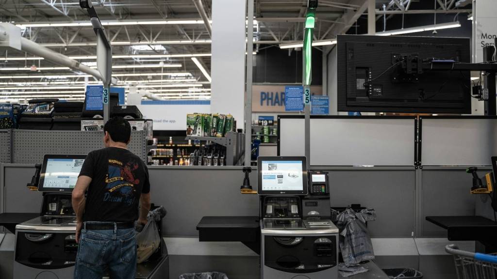 Man at Walmart using the self checkout