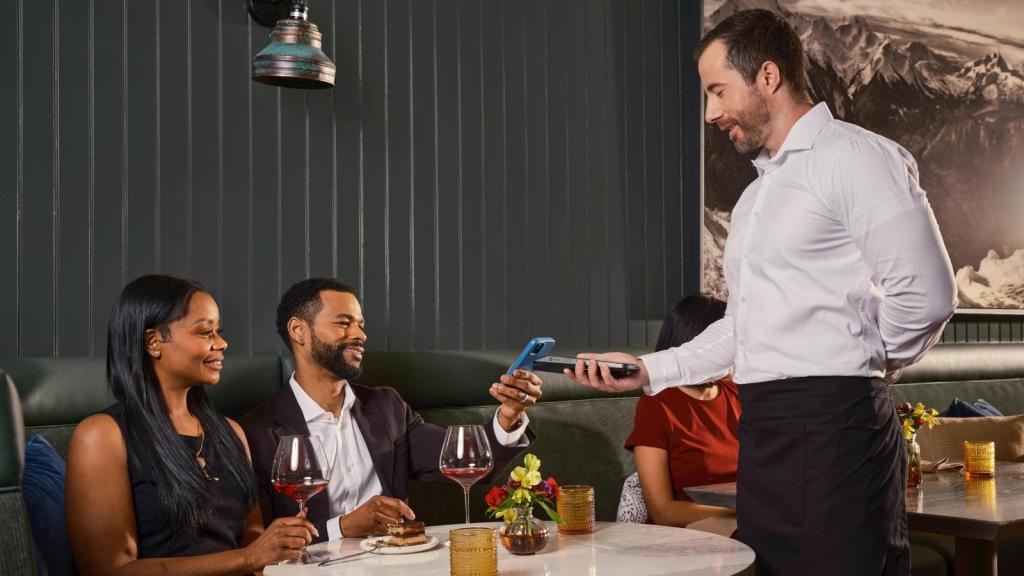 Couple trying to pay their bill at a restaurant
