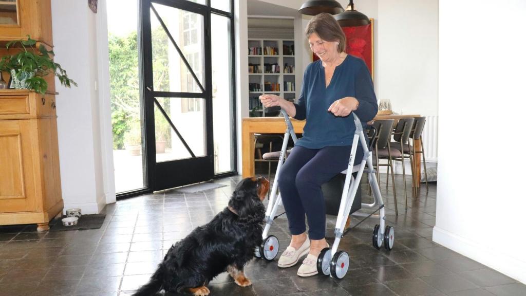 Woman sitting in a chair after having knee surgery