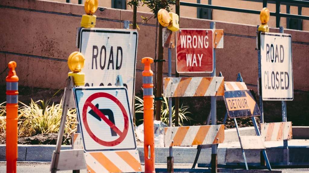 A large collection of road construction signs on the street