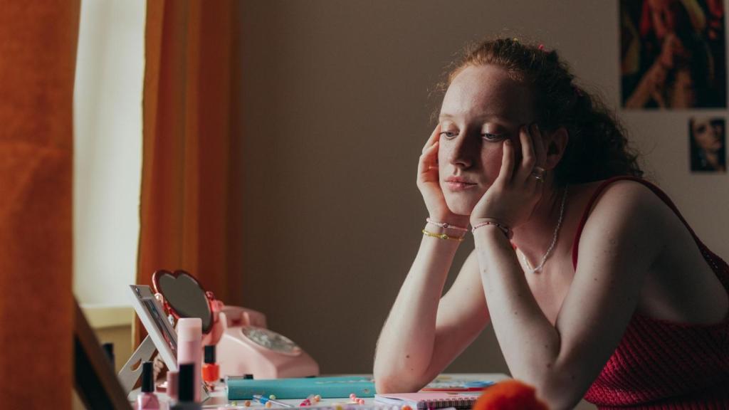 Woman holding her face and wondering how to handle her problem