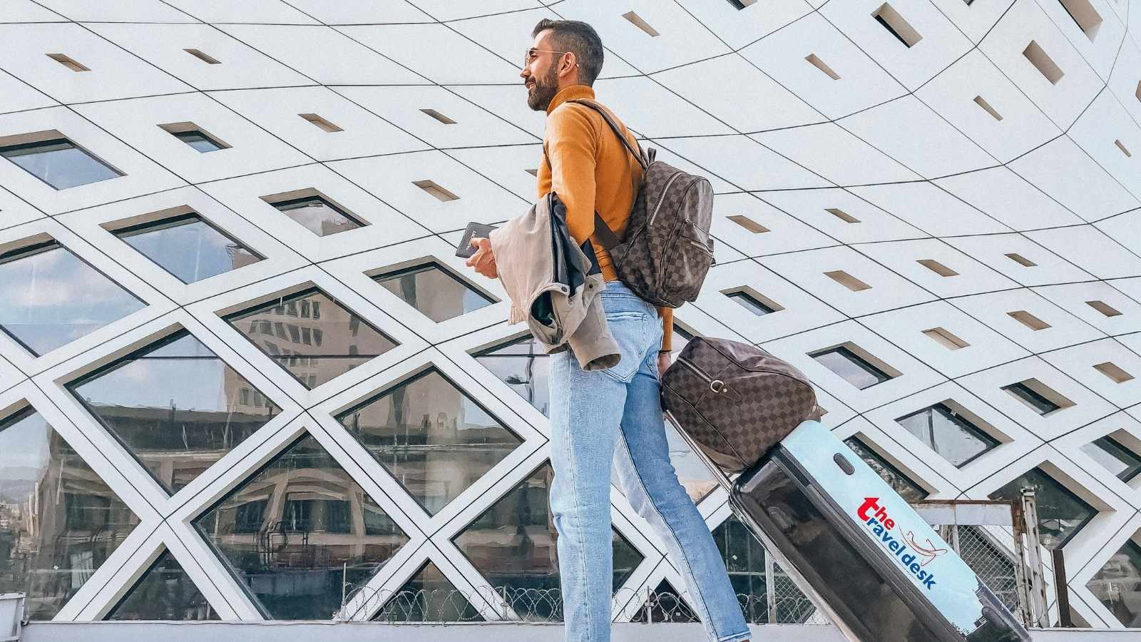 Man walking away from airport after being fired from his job