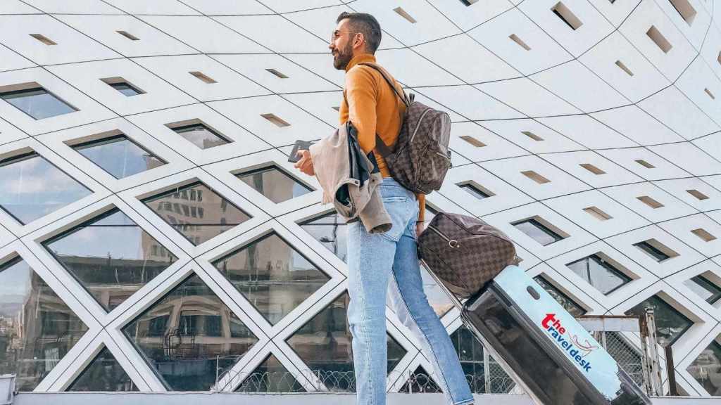 Man walking away from airport after being fired from his job