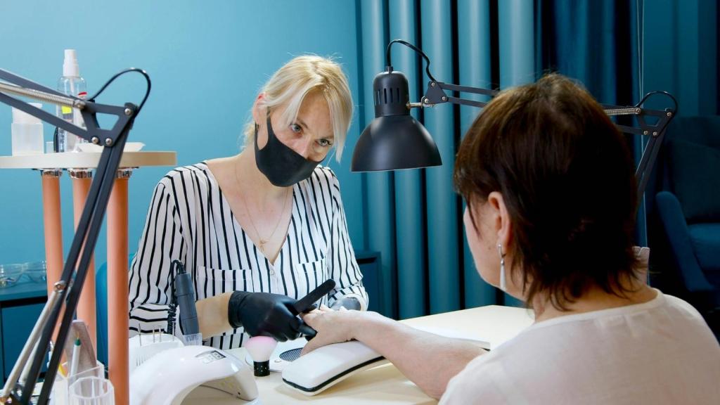 Nail salon owner doing a customer's nails
