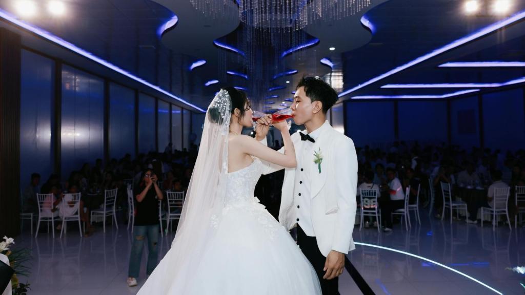 Asian couple sharing their first toast at their wedding