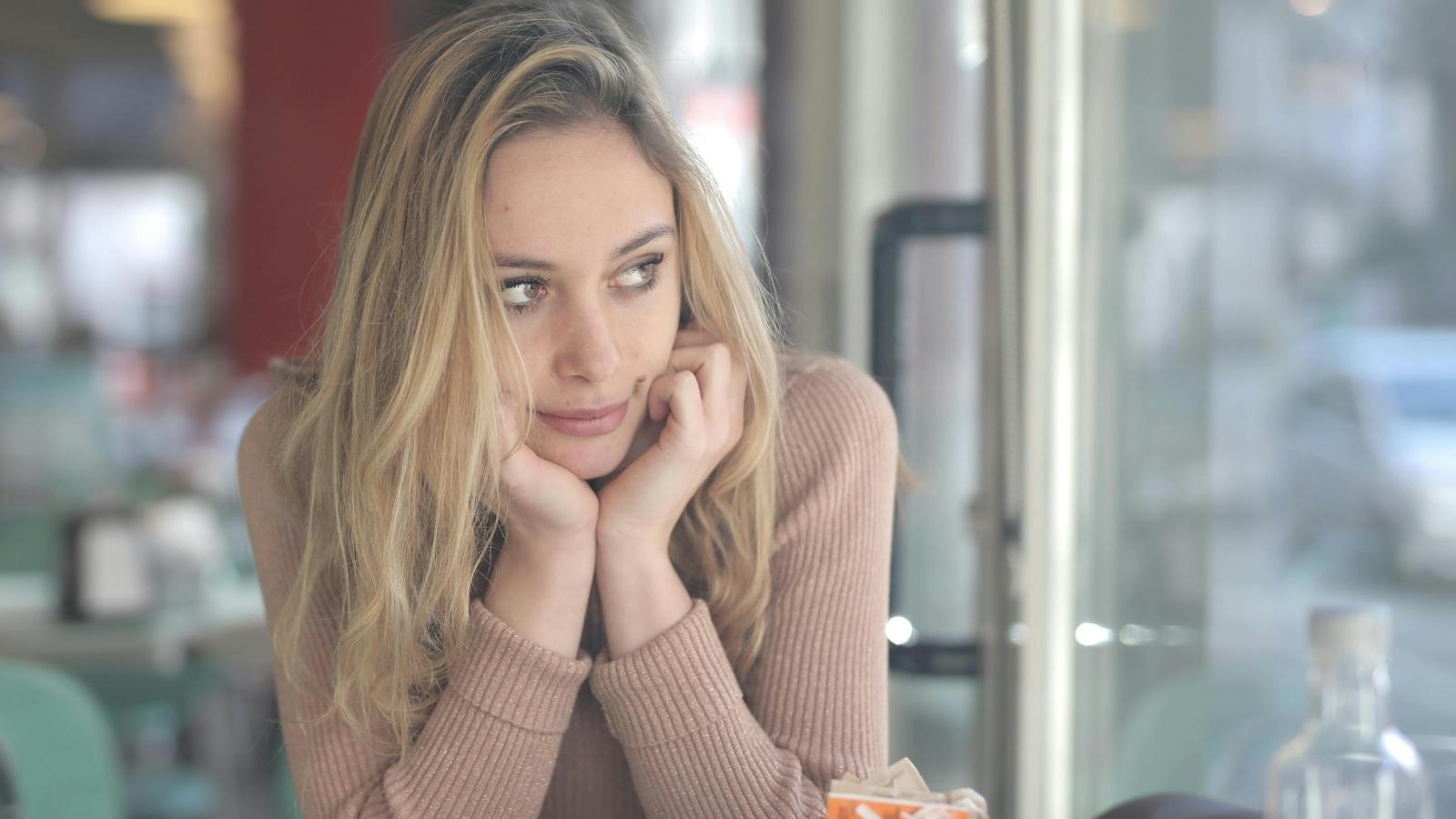 The Cost of Ambition: Why I Didnt Speak Up for the Other Intern When My Own Future Was on the Line Blonde woman holding her face and thinking about what she did