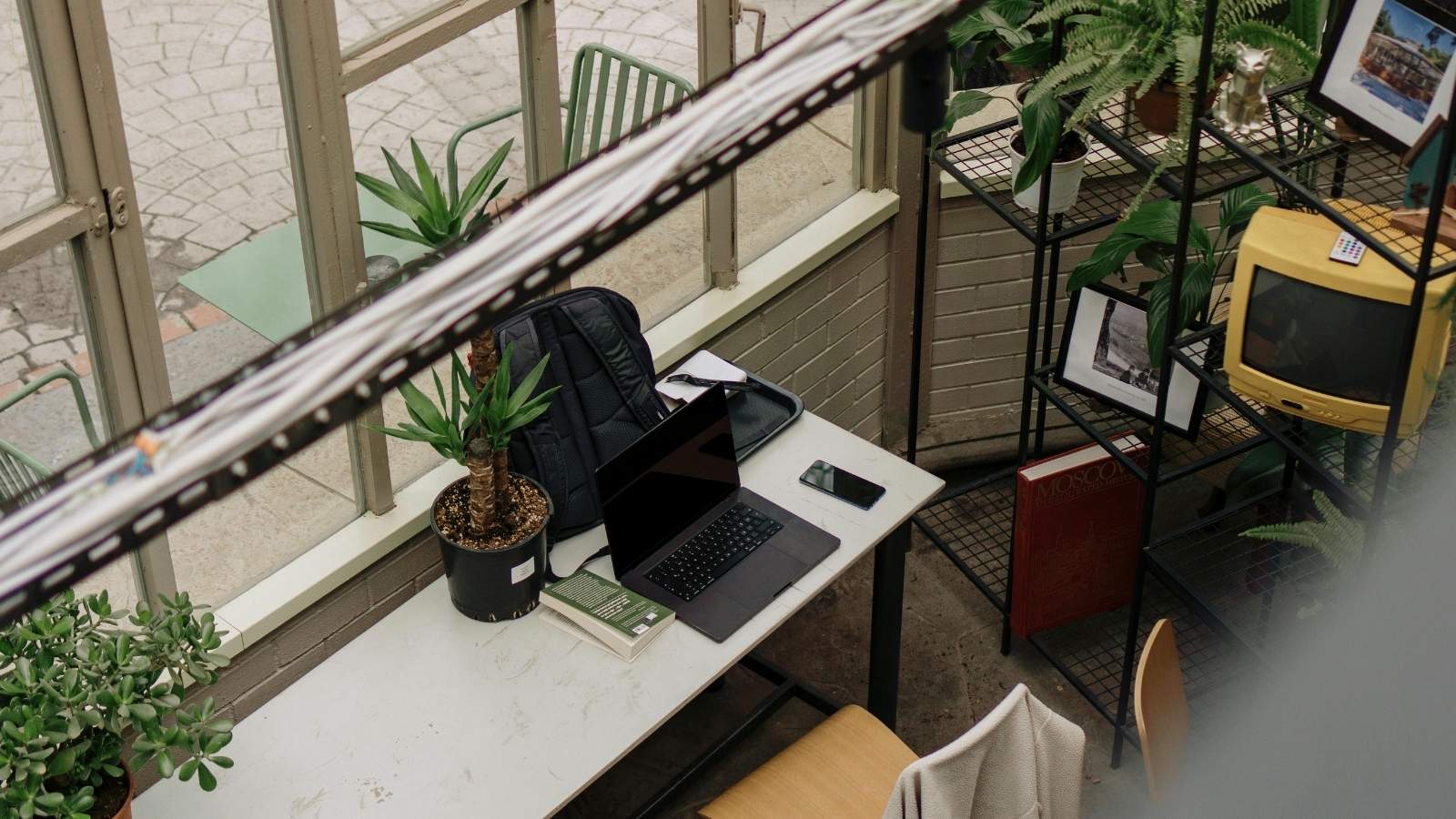 Cubicle office that's clean but has a few personal items on a shelf
