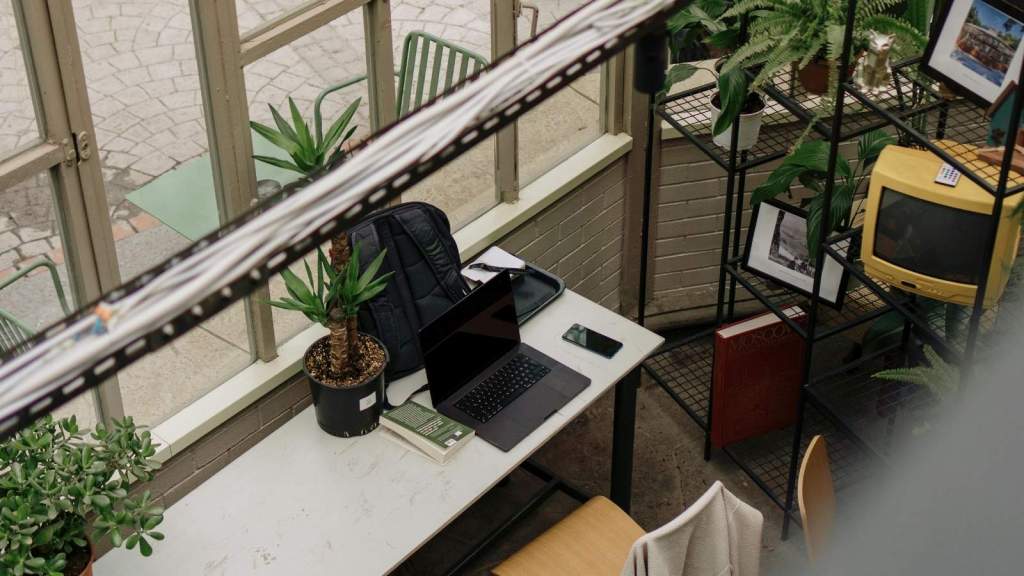 Cubicle office that's clean but has a few personal items on a shelf