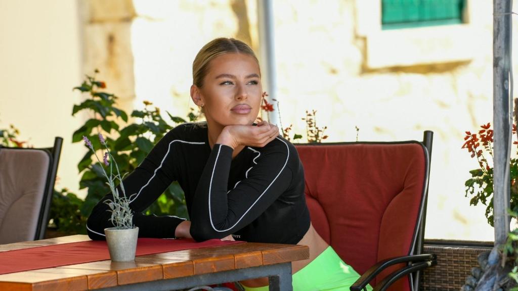 Woman sitting at a restaurant thinking about her friend