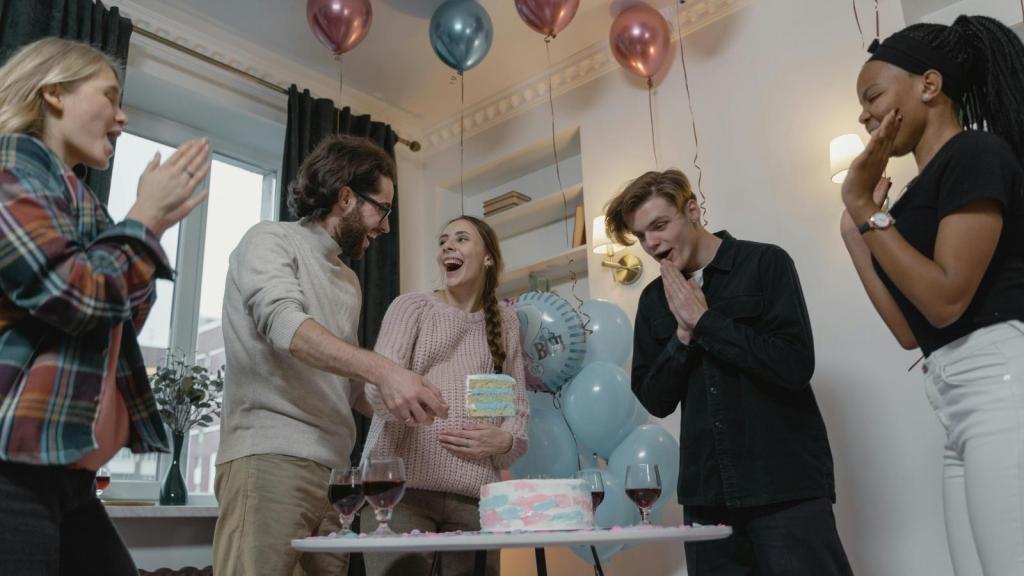 Parents to be at a gender reveal party with friends and family