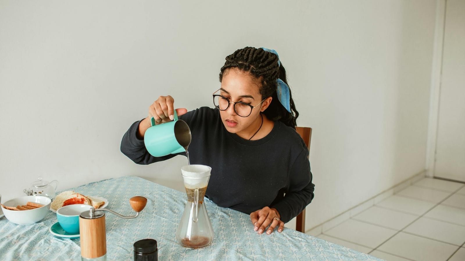 Woman Called Selfish for Cooking Breakfast for Her Sick Sister Instead of Going Out to Buy Food Woman making a drink for her sister