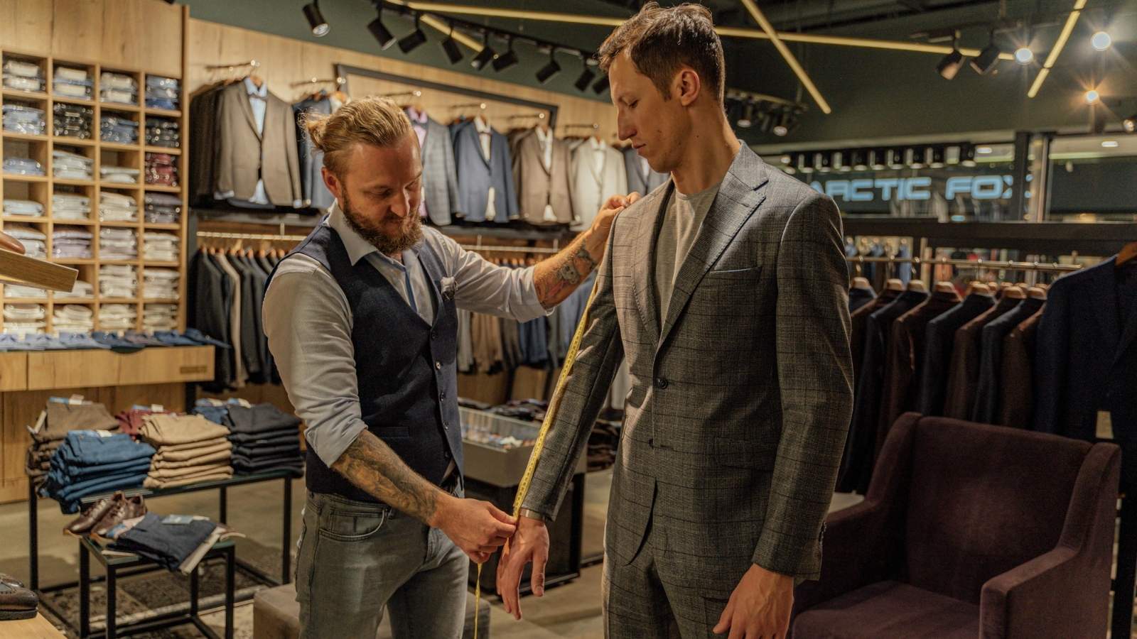 Man measuring another man for a suit