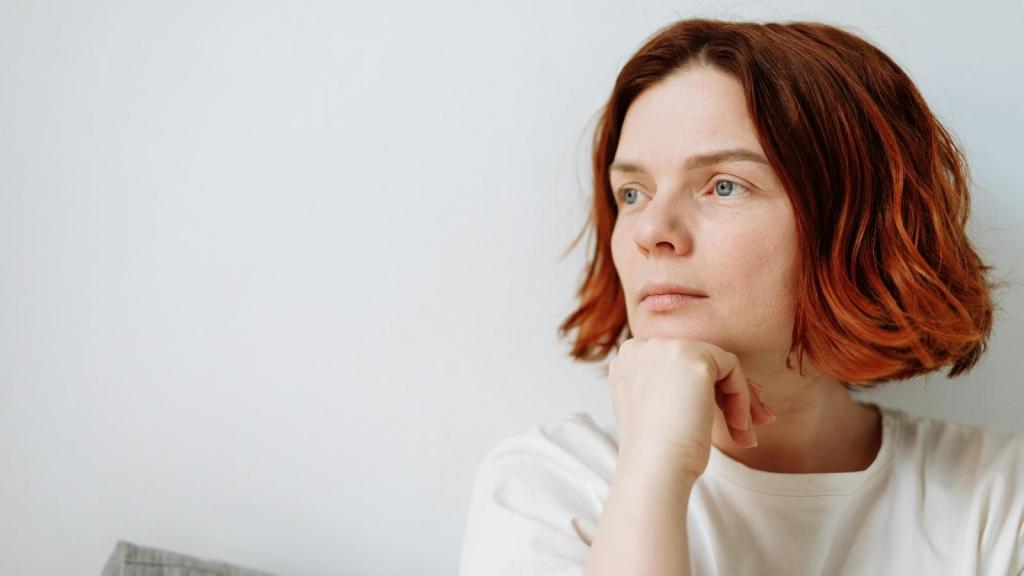 Woman thinking about how she's upset at her parents