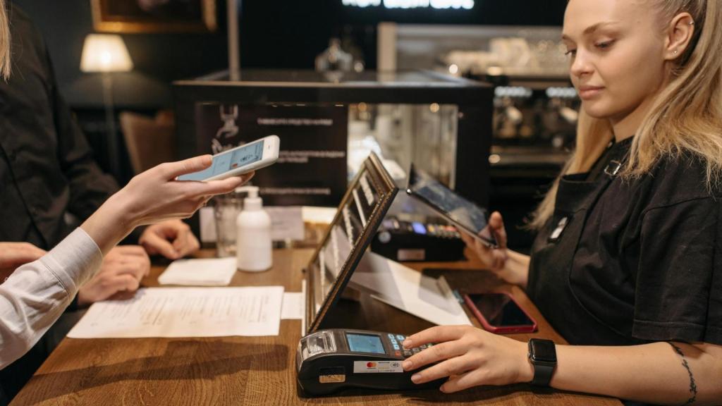 Cashier helping a customer pay with credit card