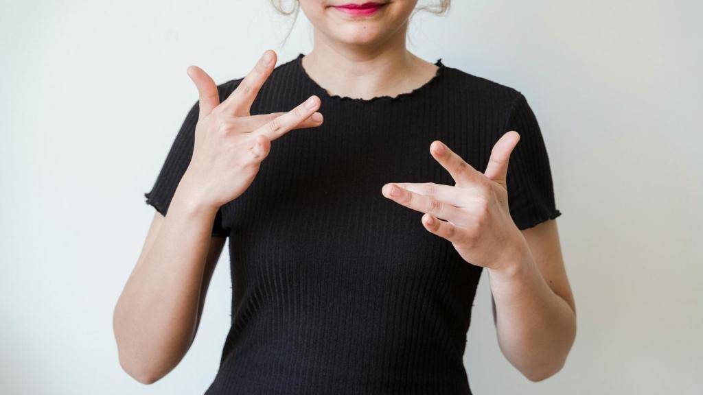 Woman using ASL to communicate with a deaf person