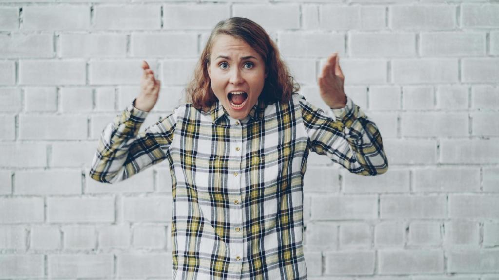 Woman holding up her arms and angry at the cashier