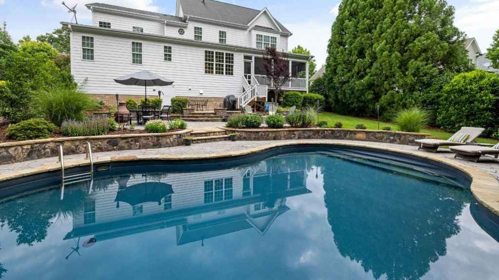 Nice pool behind a two story home