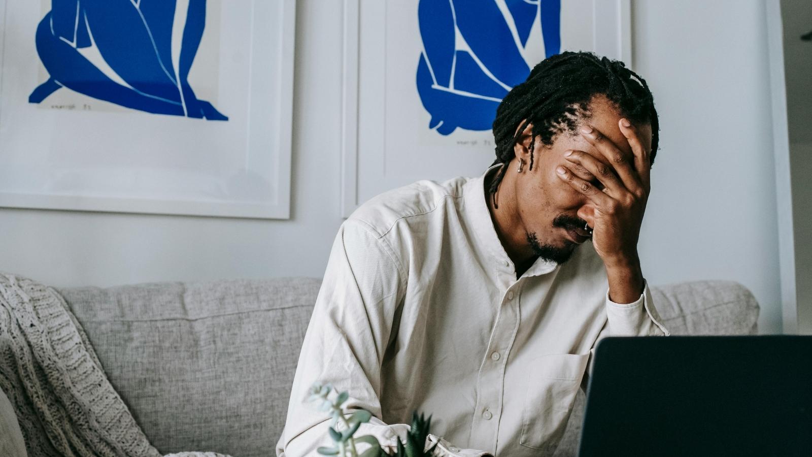 Shopper Reports Rude Convenience Store Cashier After Months of Bad Service—Then Suffers Deep Guilt After Learning She Is Entirely Homeless Man holding his head because he feels bad for a homeless woman